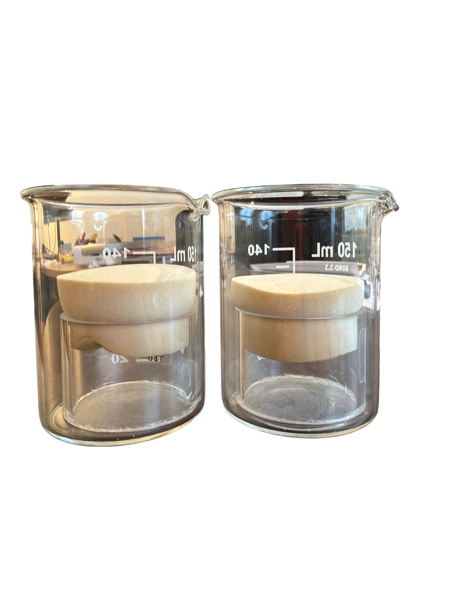 TicksDownXL in two clear glass beakers with stoppers.